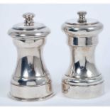 Contemporary sterling silver capstan pepper grinder, marked Cartier Sterling, and one other plated