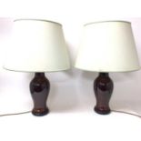 Pair of Chinese style sang de boeuf vase lamps, with circular flared shades, 69cm high