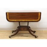 Regency mahogany, satinwood and rosewood crossbanded sofa table, the rounded rectangular drop leaf t