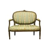 Louis XVI style carved beech two seater settee, with oval pad back and seat and well carved ribbon a