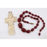 Simulated cherry amber bead necklace and a 19th century Dieppe carved ivory cross pendant
