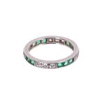 Diamond and emerald full band eternity ring with a trio of brilliant cut diamonds alternating with t