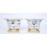 Pair of Herend porcelain jardinieres, of oval form, decorated with fruit and flowers, with lion's pa