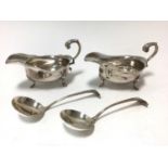 Pair of George V silver of sauce boats with a pair of Victorian silver sauce ladles