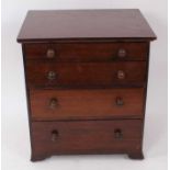 Mahogany collectors miniature chest of four graduated draws with turned bun handles
