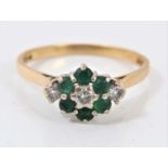 Emerald and diamond cluster ring with three brilliant cut diamonds and six emeralds in claw setting