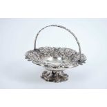 Victorian silver cake basket of circular form with embossed floral decoration, scroll border