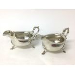 Pair of sterling silver sauceboats, by Tessiers, London 1937, with scalloped rims, scroll handles, o