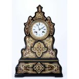 Mid 19th century French ebonised and brass inlaid mantel clock of shaped form