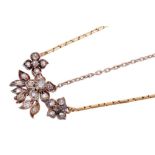 Victorian diamond pendant with old cut diamonds in a floral design with silver setting and gold, sus