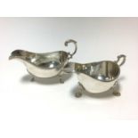 Contemporary silver sauce boat of conventional form with gadrooned border and one other