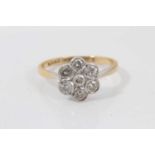 Diamond cluster ring with a flower head cluster of seven brilliant cut diamonds in platinum millegra