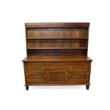 Large 18th century and later oak high dresser, with boarded rack and three drawers over twin panelle