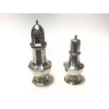 two silver sugar caster of baluster form with pierced slip in covers