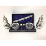 George V silver salt and pepper, of baluster form, with reeded decoration and pierced tops, hallmark