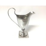 Georgian silver cream jug of helmet shaped form, on square foot