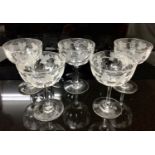 Set of five cut and etched glass champagne bowls with vine and grape decorated borders