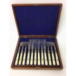 Victorian canteen of twelve pairs of silver plated fish eaters with engraved decoration and turned i