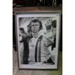 Steve McQueen Le Mans Black and White posted of his two fingered salute, in glazed frame, 72.5 x 52.