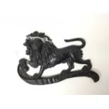 Antique cast metal plaque of a Lion