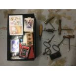 Collection of antique corkscrews, together with a collection of various 20th century playing cards,