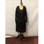 Circa 1910 Black silk crepe dress with a tiered lace skirt, long sleeves and lace inserts.