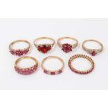 Seven 9ct gold red stone dress rings