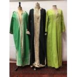 Three kaftan robes with embriodered fronts plus a long lrngth green Chinese silk brocade evening coa