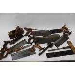 Selection of old hand tools including saws, chisels etc, mostly named