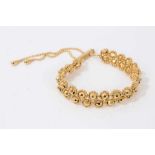 Gilt beaded bracelet with two rows of faceted gold coloured beads on adjustable gilt chain with 9ct