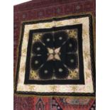 Box of textiles including black wool panel hand embroidered with metallic thread, four white work ba