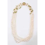 Three strand fresh water pearl necklace, interspaced with raw peridot beads, on 18ct gold clasp set