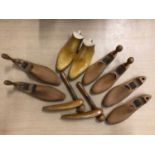 Five pairs of wooden shoe trees plus a pair of boot trees.