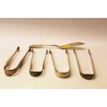 Four pairs of Georgian silver sugar tongs and a butter knife (5)