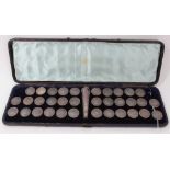 Collection of thirty four Dutch white metal buttons and handle in fitted case