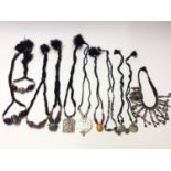 Group of eleven Eastern white metal pendant and bead necklaces