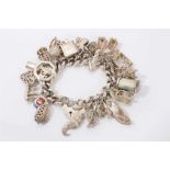 Silver charm bracelet with large quantity of silver and white metal novelty charms