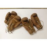 Two pairs of vintage brown leather boxing gloves