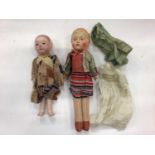 Small early mohair teddy bear with black boot button eyes, a celluloid doll in original clothing and