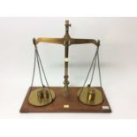 Edwardian lacquered brass weighting scales by De Grave & Co Ltd, marked County of Herts, together wi