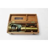 Student microscope in box, with label reading E.A. Pouzet, Opticien, Nice et Geneve