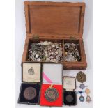 Carved wooden box containing 9ct gold Royal Horse Artillery enamelled pin, silver military pins, 9ct