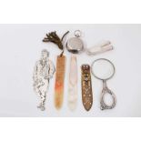 Various bookmarks including silver Robert Burns figure, silver money clip, magnifying glass and sove
