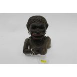 Early 20th century cast iron “Dinah” mechanical money box, with moveable arm, tongue and eyes, Rd No