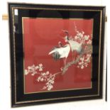 1920s / 30sJapanese embroidered silk panel on red ground in verre églomisé frame