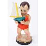 Lenci figure of a young boy in a swimming costume, holding a toy boat, spade and ball, marked 'Lenci