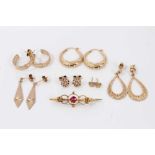 Six pairs gold earrings and yellow metal gem set brooch