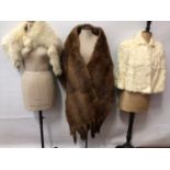 Selection of fur items including Arctic fox wrap, a wide Mink stole, cream fur cape with furrier fas