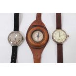First World War Officers Cyma trench wristwatch together with another similar and a compass on brown