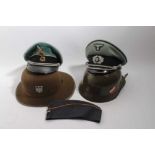 Group of 5 replica Nazi Officers caps, side caps and helmets to include a replica Afrika Korps helme